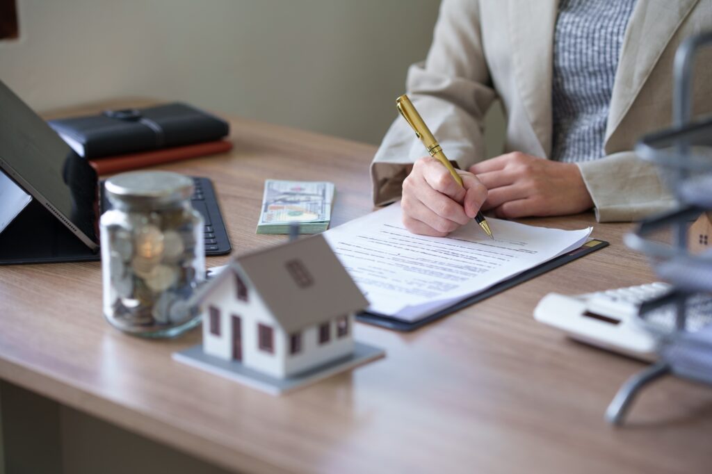 female real estate agent offers home equity loans to clients with loan calculations and home sale