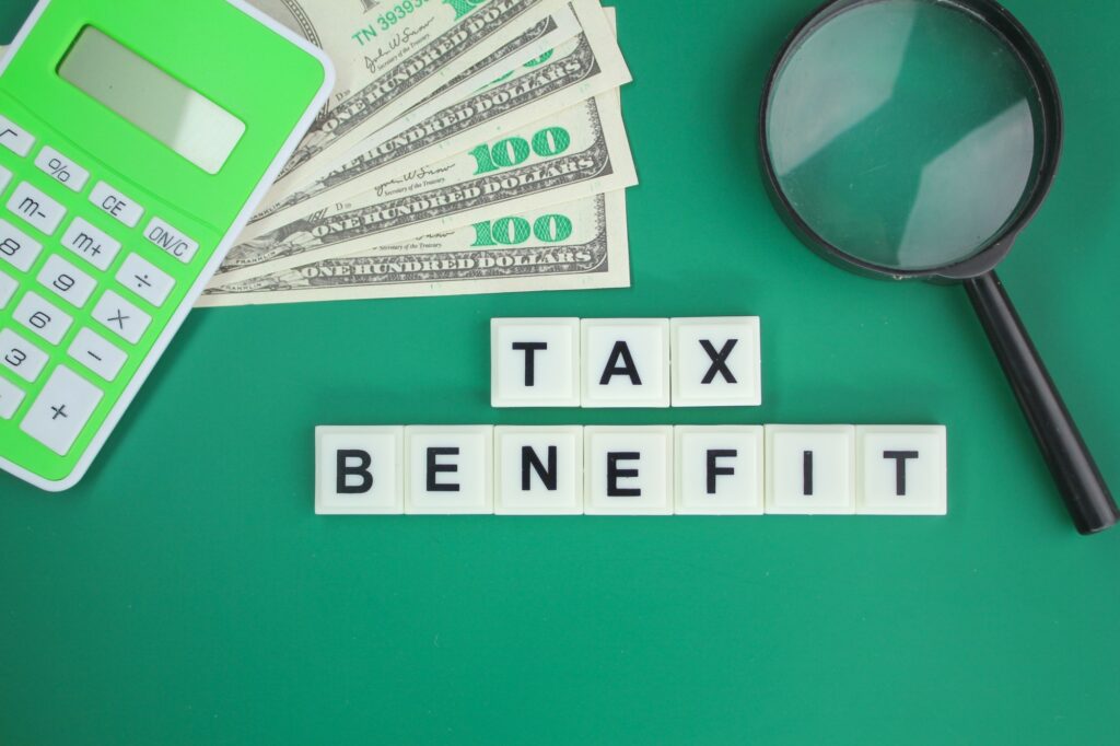 banknotes, calculators and glasses with tax interest alphabet letters